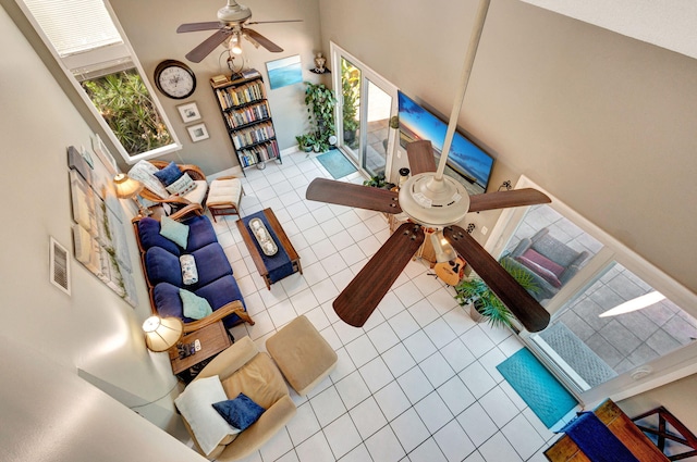 tiled living room with ceiling fan