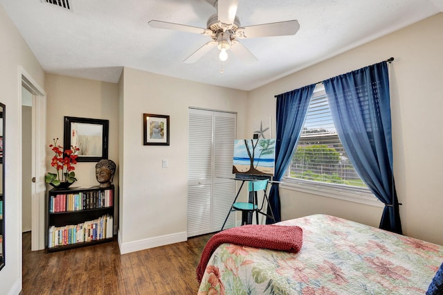 bedroom with a closet, ceiling fan, and dark hardwood / wood-style floors