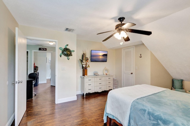 bedroom featuring ceiling fan, lofted ceiling, dark wood-type flooring, and a closet