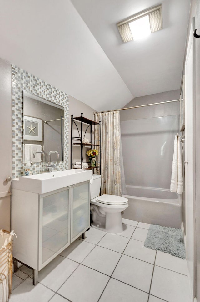 full bathroom featuring tile patterned floors, vanity, vaulted ceiling, shower / tub combo with curtain, and toilet