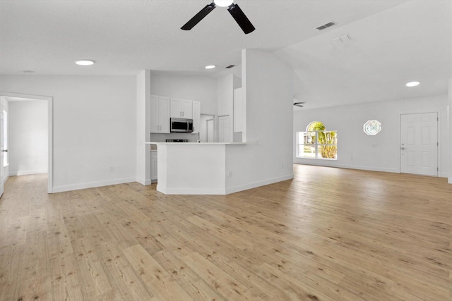 unfurnished living room featuring light hardwood / wood-style flooring, ceiling fan, and lofted ceiling