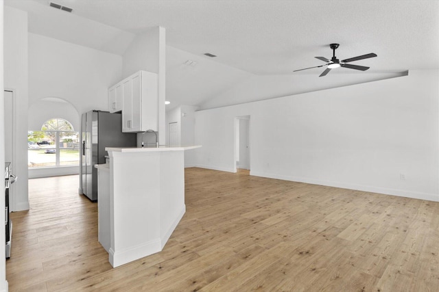 kitchen featuring white cabinets, light hardwood / wood-style flooring, vaulted ceiling, ceiling fan, and stainless steel fridge with ice dispenser