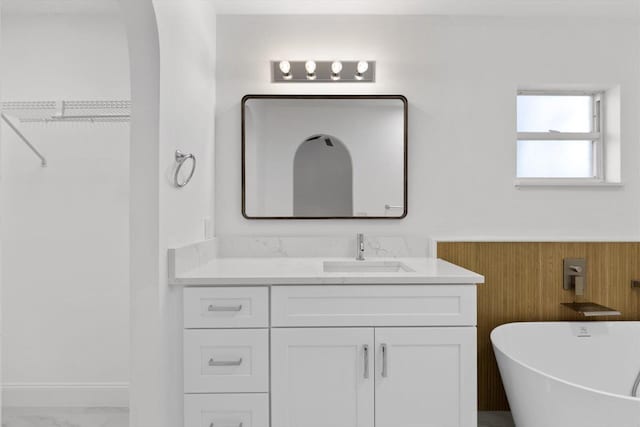 bathroom featuring vanity and a tub