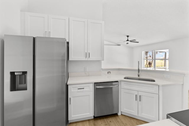 kitchen featuring white cabinets, sink, light hardwood / wood-style flooring, ceiling fan, and stainless steel appliances