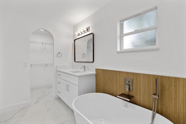 bathroom with a tub to relax in and vanity