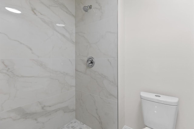 bathroom featuring toilet and tiled shower