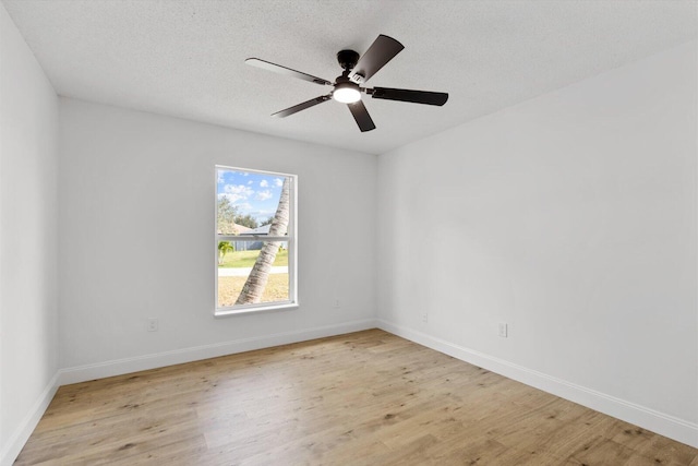 empty room featuring ceiling fan, a textured ceiling, and light wood-type flooring