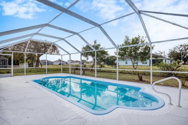 view of swimming pool featuring a lanai and a patio area