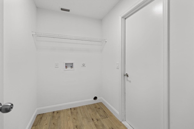 laundry area featuring hookup for an electric dryer, washer hookup, and light wood-type flooring