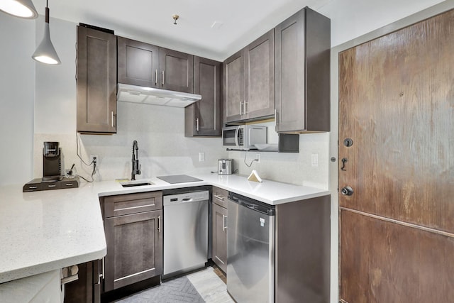 kitchen featuring stainless steel dishwasher, decorative light fixtures, dark brown cabinets, and sink