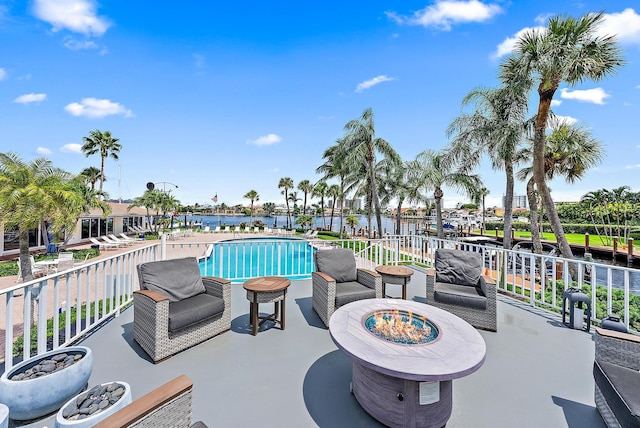 view of patio featuring a fenced in pool and a water view