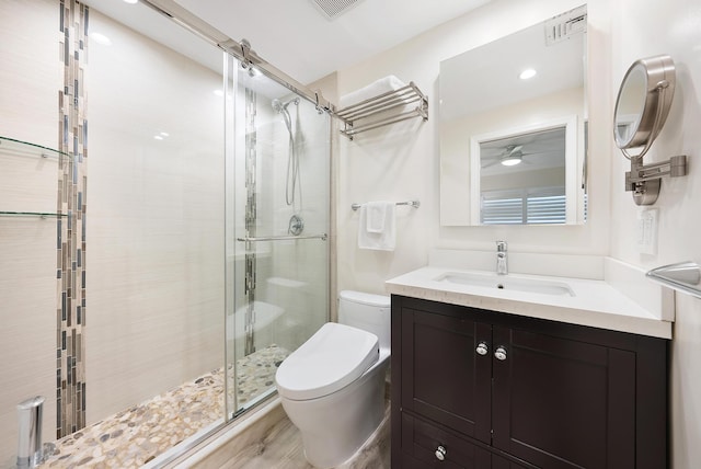 bathroom featuring walk in shower, vanity, wood-type flooring, and toilet