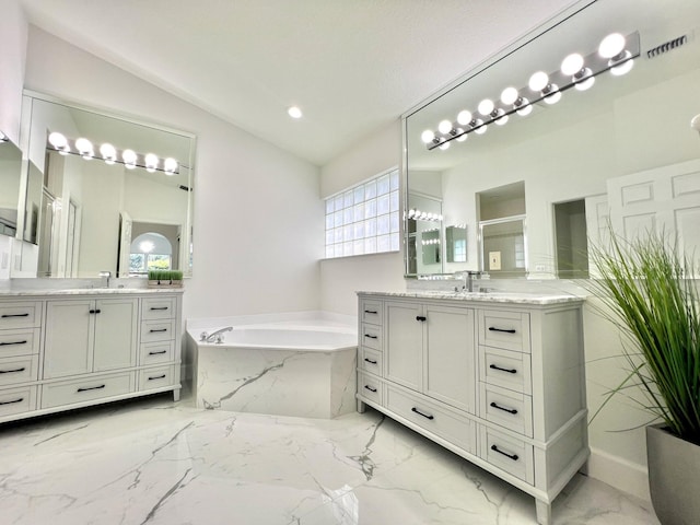 bathroom featuring vanity, separate shower and tub, and lofted ceiling