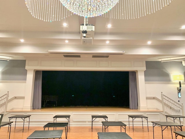 interior space featuring a chandelier, wood-type flooring, and a garage door opener