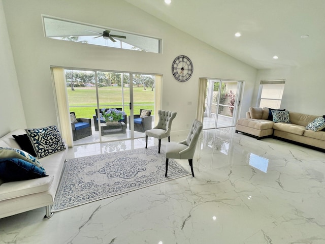 living room with high vaulted ceiling and ceiling fan