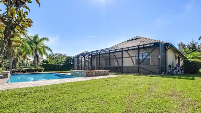 view of swimming pool with a lawn and glass enclosure