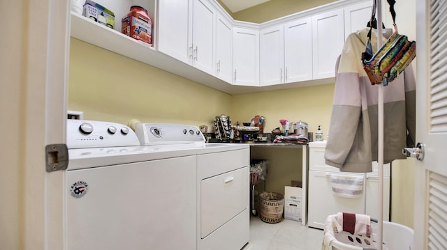 laundry area with light tile patterned floors and washer and clothes dryer