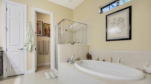 bathroom featuring tile patterned flooring and shower with separate bathtub