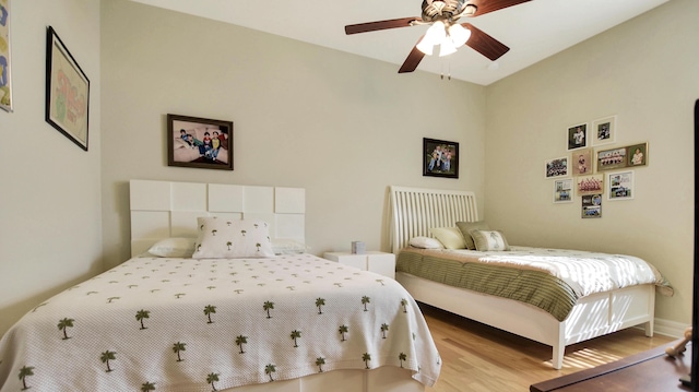 bedroom with ceiling fan and light wood-type flooring