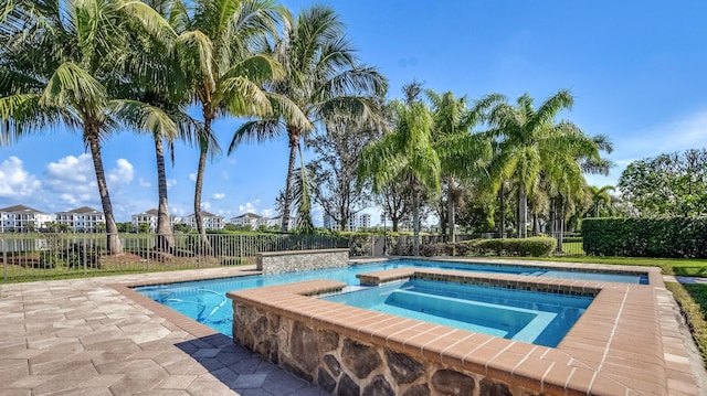 view of swimming pool featuring an in ground hot tub