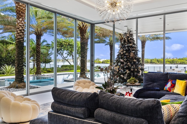 sunroom / solarium featuring a notable chandelier