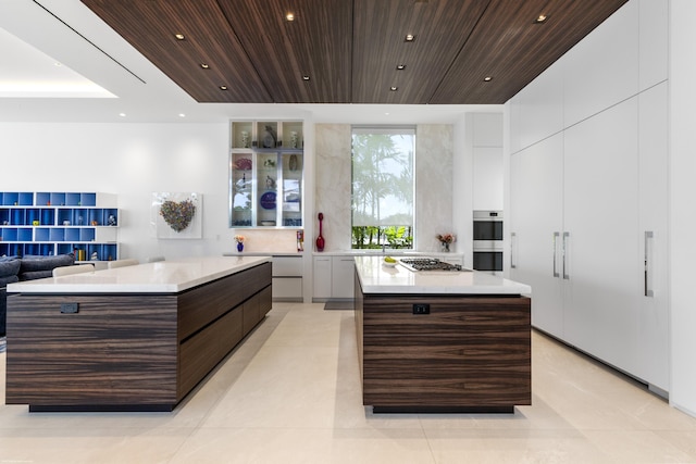 kitchen featuring wood ceiling, dark brown cabinetry, a spacious island, and appliances with stainless steel finishes