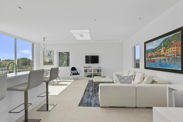 living room featuring light tile patterned floors and a notable chandelier