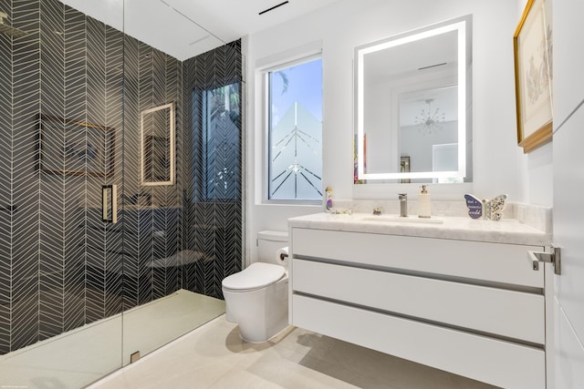 bathroom featuring vanity, toilet, and a shower with door