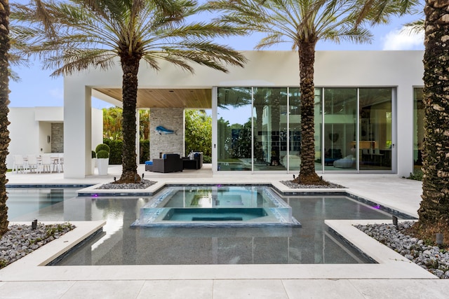 view of swimming pool with outdoor lounge area, an in ground hot tub, and a patio