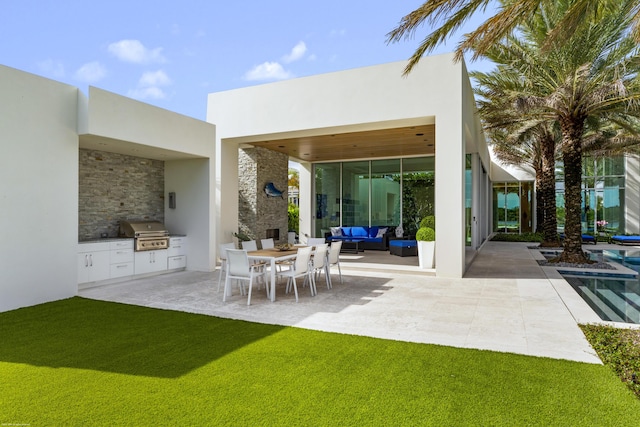 rear view of house with outdoor lounge area, area for grilling, a patio area, and a lawn