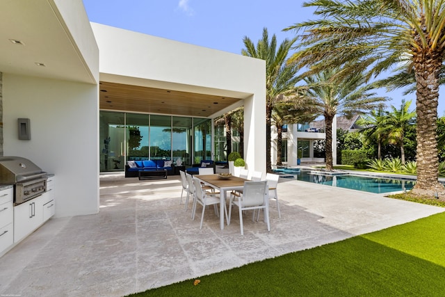 view of patio / terrace with an outdoor living space, area for grilling, and exterior kitchen