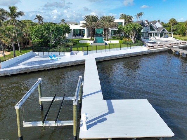 view of dock featuring a yard and a water view