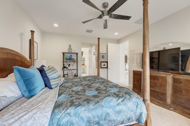 bedroom with light carpet, connected bathroom, and ceiling fan