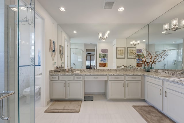 bathroom with walk in shower, vanity, toilet, and a notable chandelier