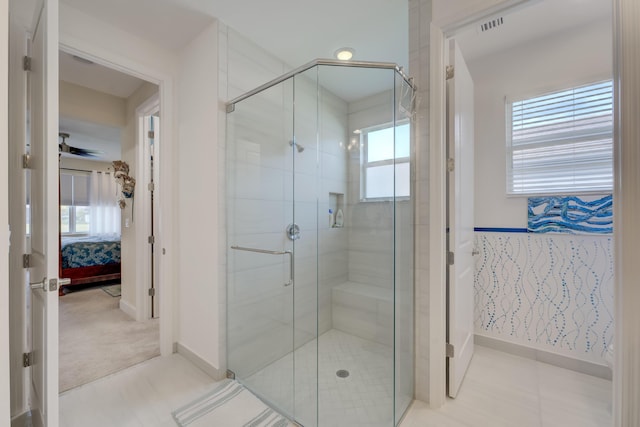 bathroom featuring a shower with shower door