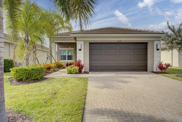 view of front facade featuring a front yard and a garage