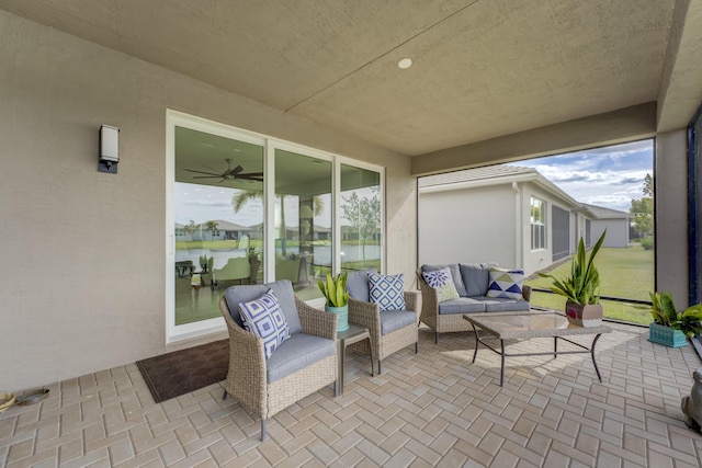 view of patio featuring an outdoor living space and a water view