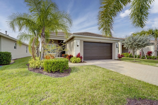 view of front of property with a front yard and a garage