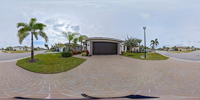 view of front of house with a garage and a front yard