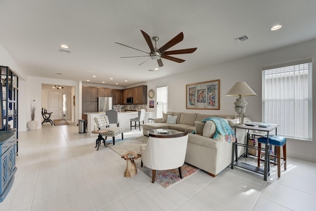 living room with light tile patterned flooring and ceiling fan