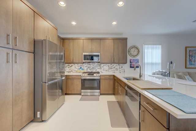 kitchen featuring appliances with stainless steel finishes, sink, and decorative backsplash