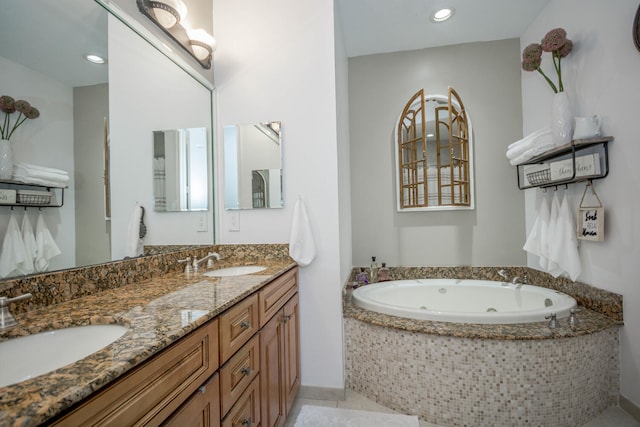 bathroom with vanity and tiled tub