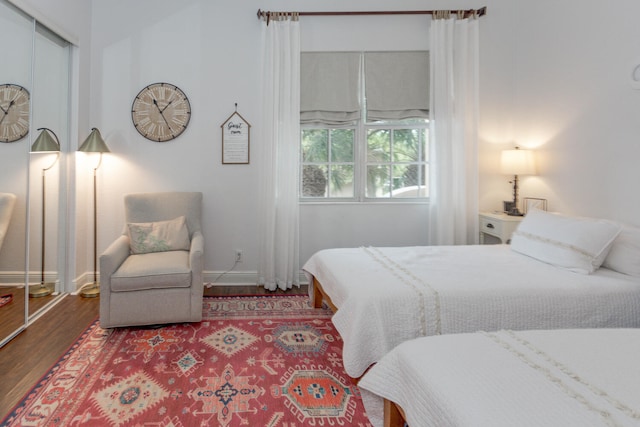 bedroom with hardwood / wood-style floors and a closet