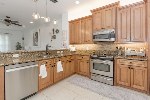 kitchen featuring stone counters, sink, and stainless steel appliances