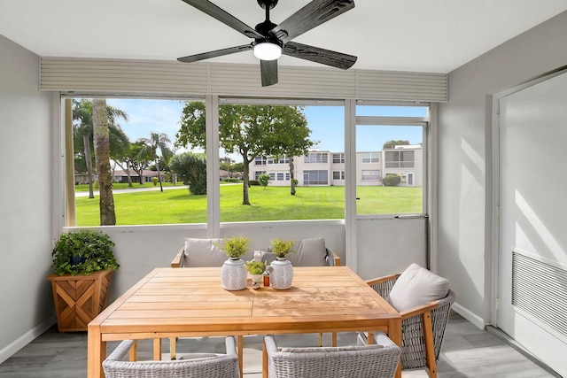 sunroom / solarium with a wealth of natural light and ceiling fan