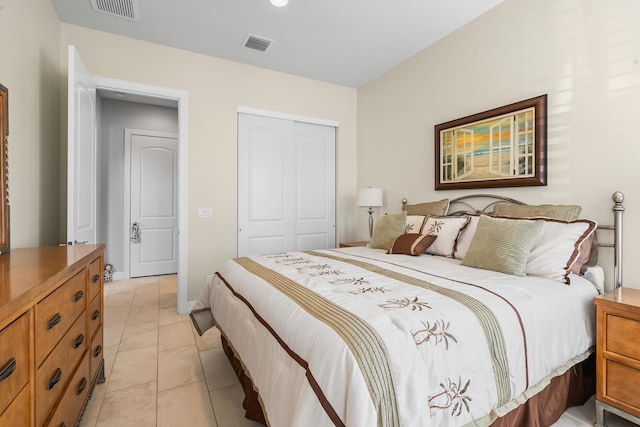 tiled bedroom with a closet