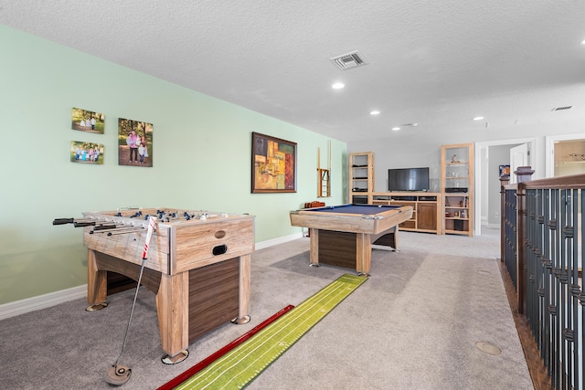 game room with light colored carpet, a textured ceiling, and pool table