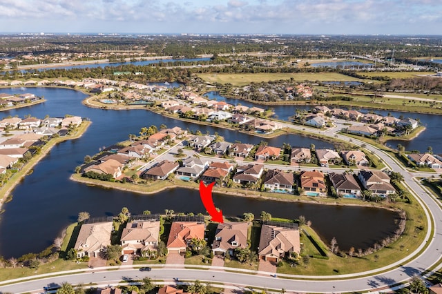 drone / aerial view with a water view and a residential view