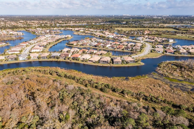 drone / aerial view featuring a residential view and a water view