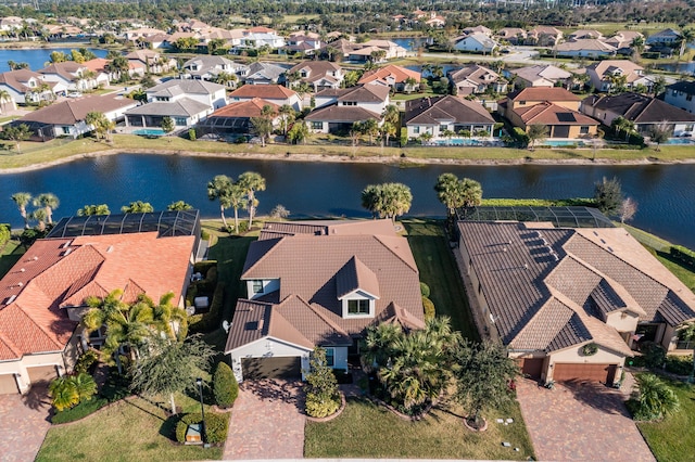 birds eye view of property with a water view and a residential view